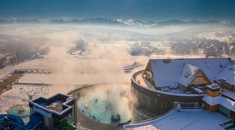 From Kraków: Thermal Baths Evening or Morning Experience - Indoor pools, outdoor water, and mountain views