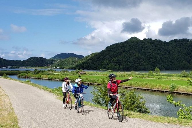 Kinosaki Onsen Cycling Tour Kinosaki & Riverside Experience - Following the river toward fields and open country